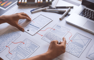 This is an image of wire frames drawn on paper to plan out and optimise the user experience of a system