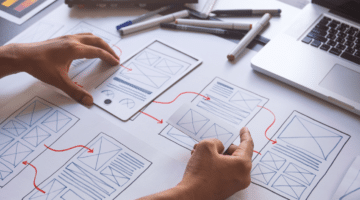 This is an image of wire frames drawn on paper to plan out and optimise the user experience of a system